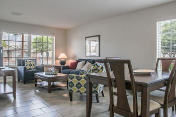 A living room and dining room with a table and chairs